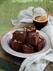 Pieces of cake chocolate brownies on wooden background. Homemade baking. Copy space
