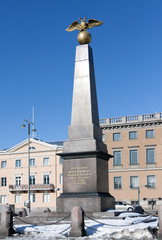 Obraz premium Granite obelisk with two headed golden eagle of the Empress Alexandra on Market Square in Helsinki, Finland
