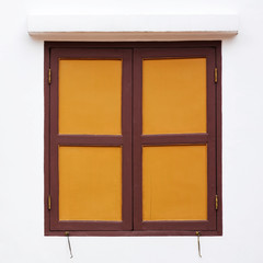 Fototapeta premium brown and yellow wood window at white building