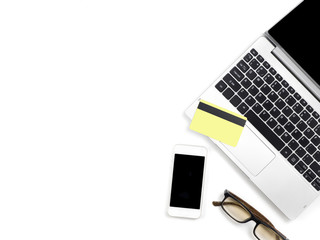 Minimal and Modern white office desk with laptop and glasses and other supplies with pay credit card, Top view with space for copy paste your  text, Concept Minimal and Modern background