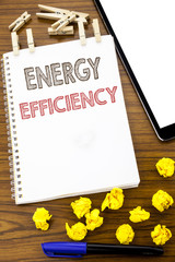 Writing text showing Energy Efficiency. Business concept for Electricity Ecology written on note paper with folded Meaning Thinking paper on the wooden background with marker and coffee