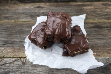 Appetizing chocolate cakes are located on an old wooden background close-up.