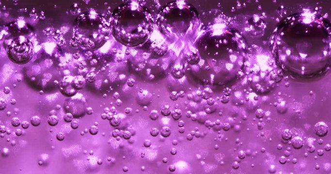 Extreme macro of bubbles in lilac jello cream (gel). 4k. Micro.