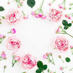 Floral round composition with roses, leaves and buds on white background. Flat lay, top view. Frame background