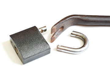 Cracked padlock and pry bar. Isolated. White background