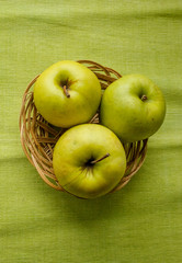 Small basket with fruits. Apples, lemons, carrot on the table. Jar of honey, bowl of oatmeal. Green tablecloth. Healthy eco lifestyle. Food blog illustrations. Cooking fruit salad. Pile of apples