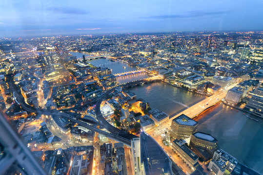 Aerial view of London Bridges and skyline at night, London