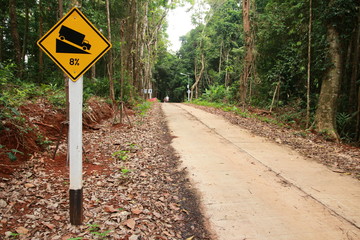 road sign warning in Koh Kood island big trees side way 