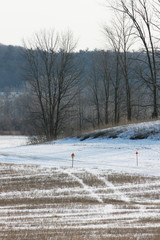 Winter Snowmobile Trail across farmland in the midwest. Vertical