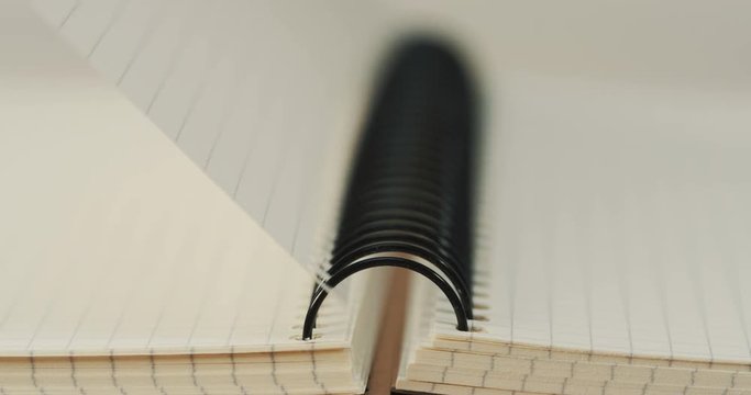 Close up of the copybook and its blanc pages flipping. Macro shooting
