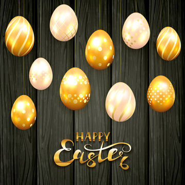 Golden Easter eggs on black wooden background