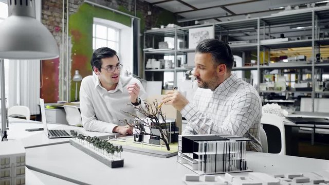 Two men working in design and engineering architecture office.