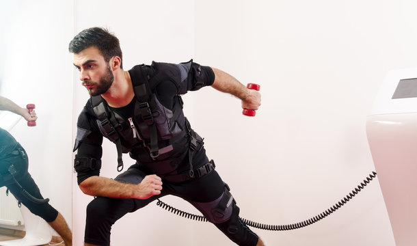 Man in Ems suit exercising triceps 