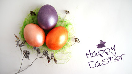 three eggs in a green nest, dry branches on a white background. a collage by sacred Easter
