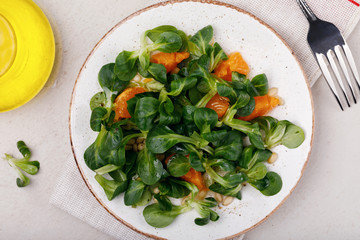 Dietary lunch: gentle salad Korn with pine nuts and tangerine. Dish for vegetarians, top view