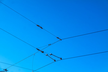 Railroad overhead lines against clear blue sky Contact wire