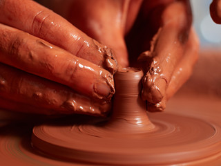 production process of pottery. Forming the clay cover of the kettle on the potter's wheel.