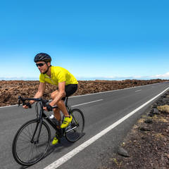 Road biking cyclist man training on bike professional cycling athlete riding racing bicycle in competition race on open road biking with high intensity on highway on workout for triathlon.