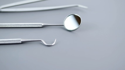 Set of dentist tools on gray background