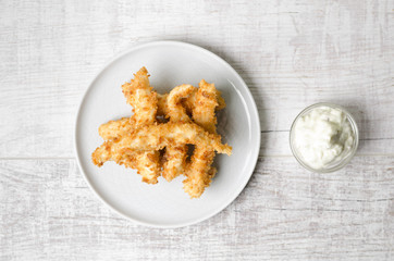 Fried chicken with sauce on a gray background