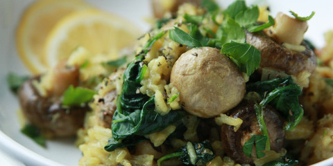 Yellow rice with mushrooms and spinach. Vegan dish