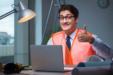 Construction architect working on drawings late at night
