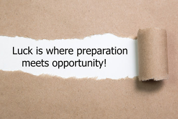 The quote Luck is where preparation meets opportunity, appearing behind torn paper.
