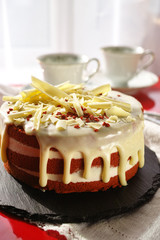 Classic American dessert red velvet cake is traditionally a red, red-brown chocolate layer cake, layered with white cream cheese or ermine icing
