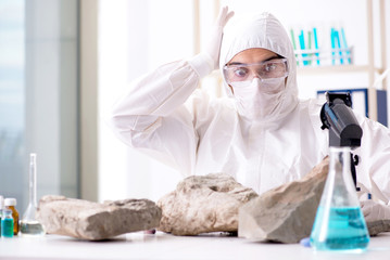 Scientist looking and stone samples in lab