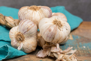 French garlic braid close up on blue wooden table