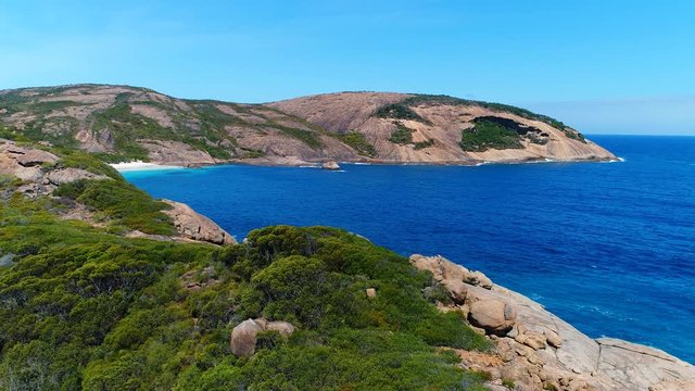 Aerial view of picturesque coastline of Hellfire Bay, colorful cliffs and rocks protruding above crystal clear waters of Southern Ocean - Cape Le Grand, Esperance, Western Australia from above, 4k UHD