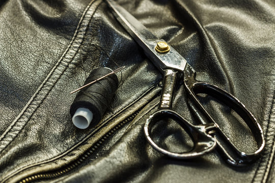 Sewing Leather Jacket, Repair Of Leather Jacket Scissors, Thread, Close-up. Products Of Leather.