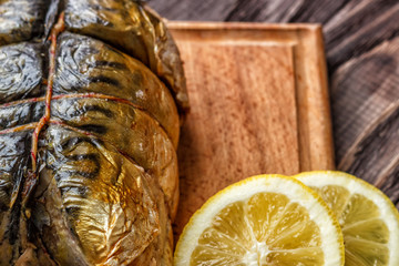 Smoked fish mackerel on a wooden background, close-up, top view.