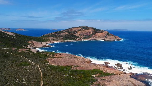 Aerial view of picturesque coastline of Hellfire Bay, colorful cliffs and rocks protruding above crystal clear waters of Southern Ocean - Cape Le Grand, Esperance, Western Australia from above, 4k UHD