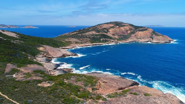 Aerial view of picturesque coastline of Hellfire Bay, colorful cliffs and rocks protruding above crystal clear waters of Southern Ocean - Cape Le Grand, Esperance, Western Australia from above, 4k UHD
