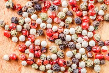The pepper mix on a wooden background