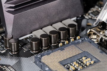 Close up on the cpu socket, focus on the surrounding capacitors