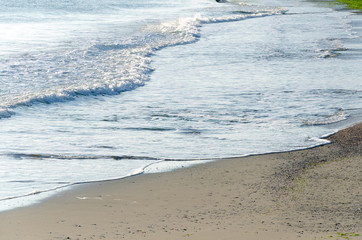 Natural background of waves rolling into the beach