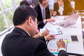 business team meeting concept : people group hand plan financial chart graph