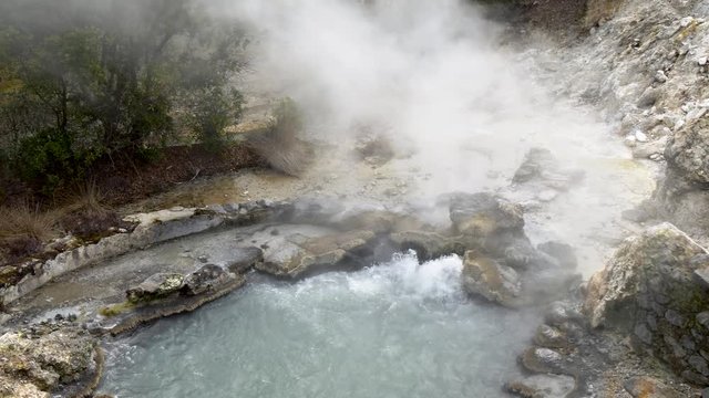 Geothermal hot spring in the central village of Furnas, Sao Miguel Island, Portuguese archipelago of the Azores. Slow motion shot. 