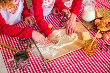 Process of cooking dessert. Baby and female hands knead the dough