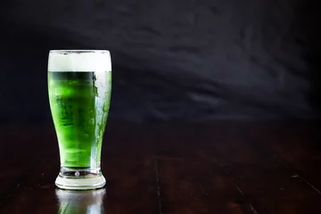 Foto op Canvas A classic pilsner with green beer on rustic wood table. © Satoshi Kina