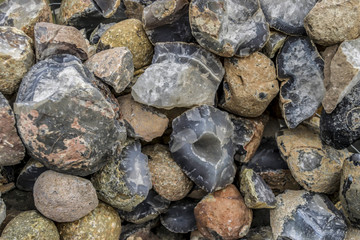 Stones, rocks and minerals close-up. Agate and quartz texture close-up. Stone inside. Background with stones. Decorative rocks. Decorative stones. Many stones lie together. 