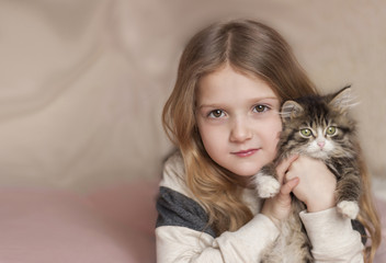 portrait of a little girl with a kitten