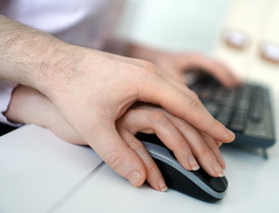 Sexual harassment at work. Man touching secretary's hand.