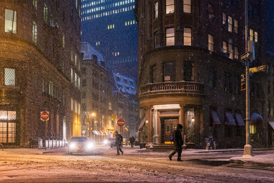 People cross the street in New York City during a snow storm - Powered by Adobe
