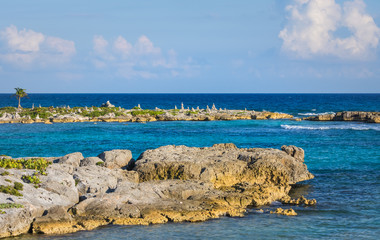 Landscape with balanced rocks, stones on a rocky coral pier. Turquiose blue Caribbean sea water. Riviera Maya, Cancun, Mexico.