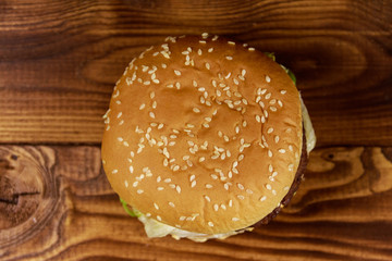 Delicious big hamburger on wooden table