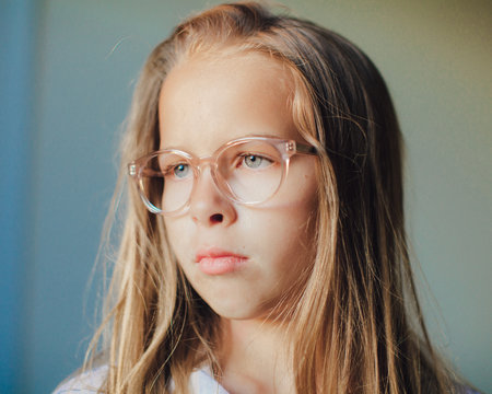 Portrait of a Young Girl with Long blonde hair Wearing Glasses