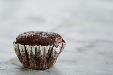 Tasty muffins arranged in pattern on light textured background, close-up, shallow depth of field, selective focus.